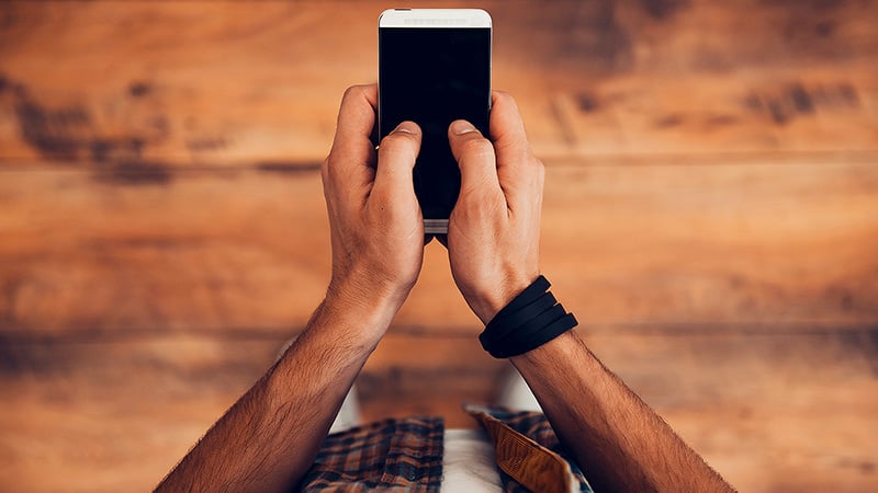 Hands holding a phone. 