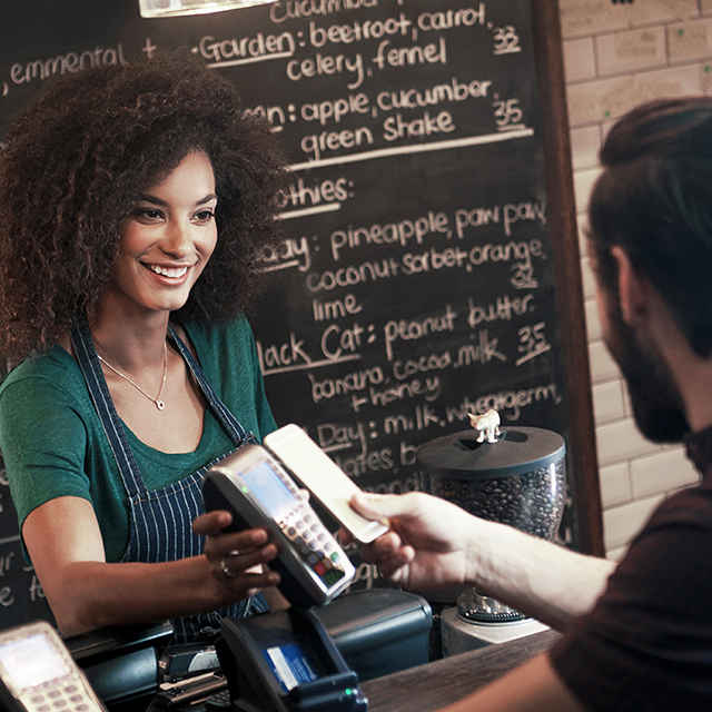 Woman outside café with phone  