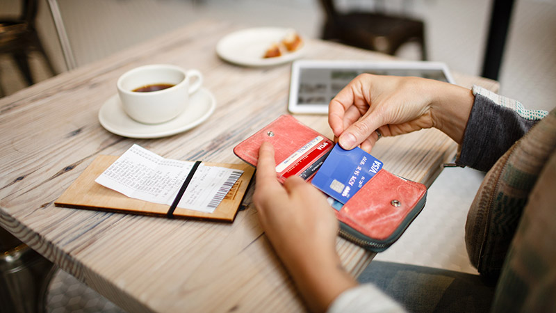 Customer taking out their Visa EMV chip card to pay for a meal overseas