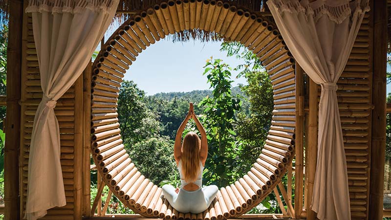 Caucasian woman practicing yoga on vacation on Bali island