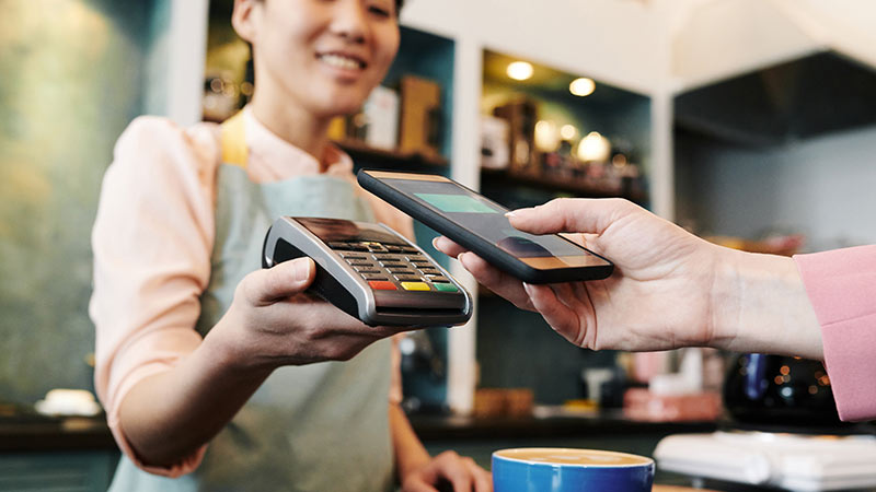 customer using phone to make contactless payment