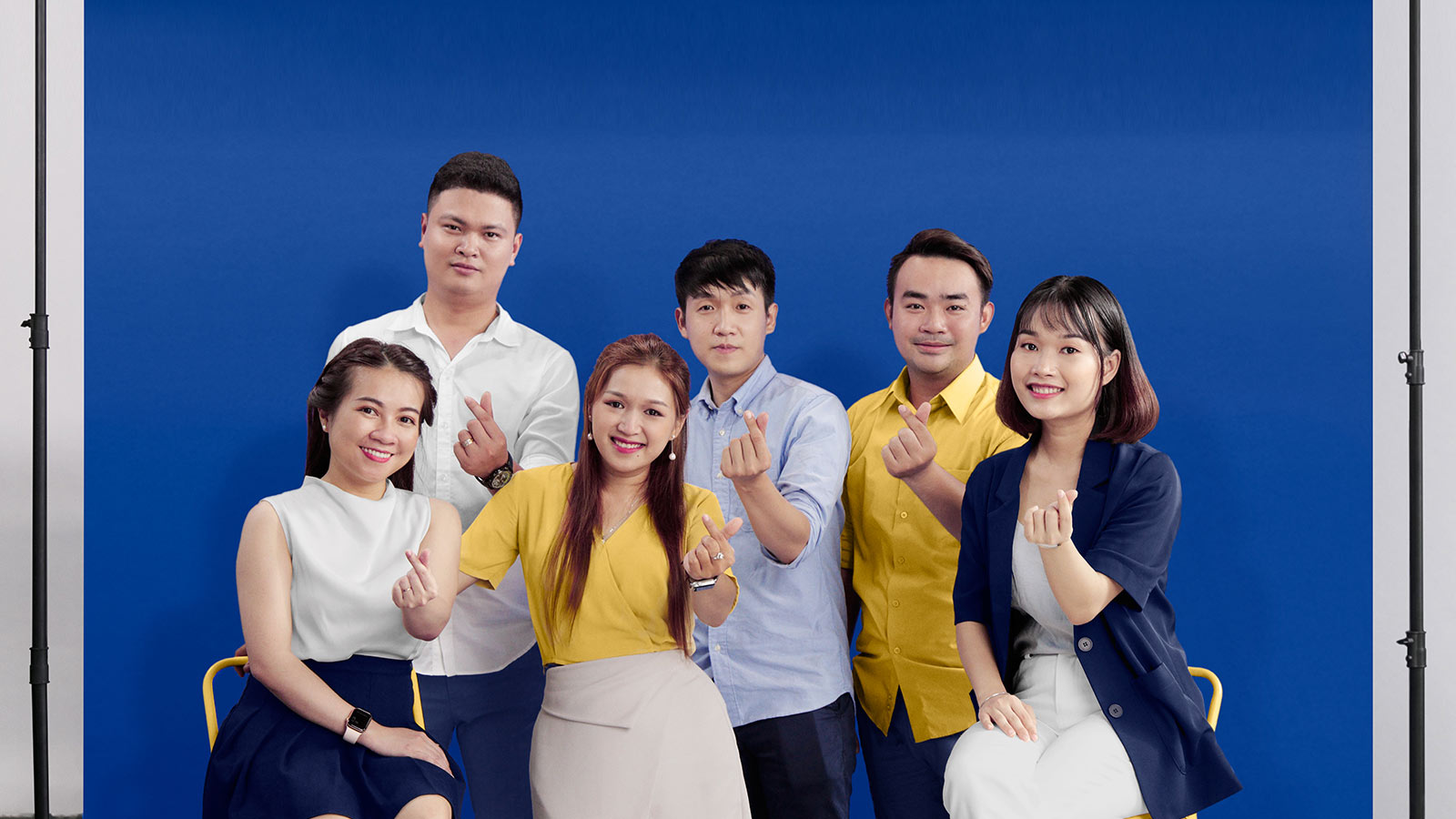 A group of people posing for a picture as a gesture of support for local businesses.