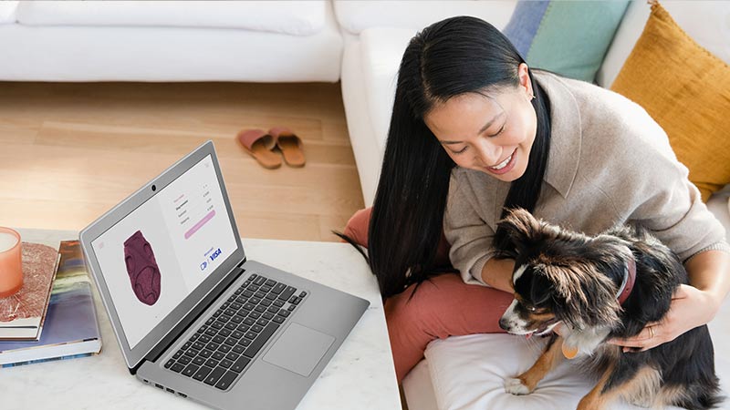 women hugging dog infront of laptop